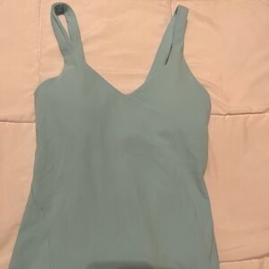 Three align tanks. The tan one is cropped and the blue and pink ones are not.
